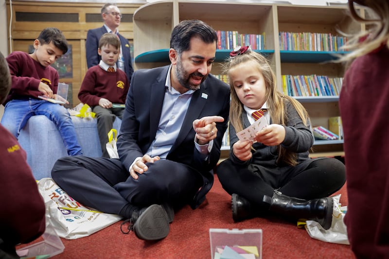 Mr Yousaf engages with pupils during Scotland's Book Week at Craigentinny Primary School in Edinburgh, in November. Getty Images