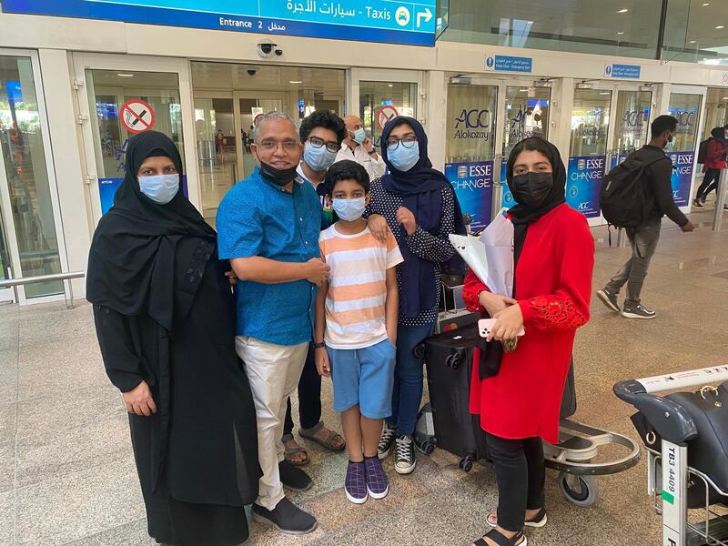 Dubai businessman Younus Hassan meets his family at Dubai International Airport on their return from India. His wife Hafsa Younus, left,  and children Mohammad Hani Hamdan, Mohammad Hilal, Nihala and Nujum were able to travel back to the UAE because they have 10-year golden UAE residency visas and are exempt from the travel restrictions. Courtesy: All photos by Younus Hassan