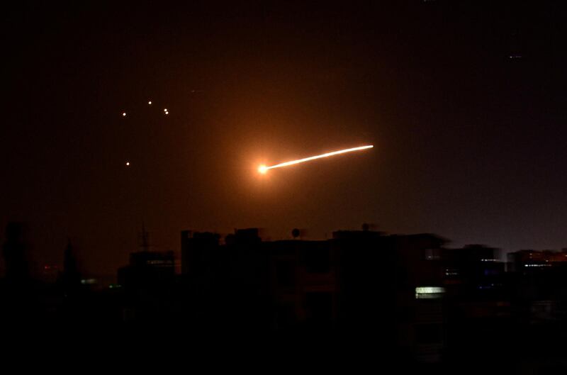 FILE PHOTO: A streak of light is seen in the night sky in the vicinity of the Syrian capital Damascus during what Syrian authorities said was an Israeli air strike, in this handout released by state news agency SANA on February 24, 2020. SANA/Handout via REUTERS ATTENTION EDITORS - THIS IMAGE WAS PROVIDED BY A THIRD PARTY. REUTERS IS UNABLE TO INDEPENDENTLY VERIFY THIS IMAGE/File Photo