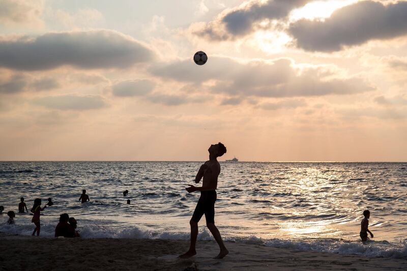 An Egyptian man plays with a ball on the beach during the sunset hours on the northern coast in Egypt.  EPA
