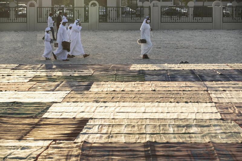 Eid prayers, also known as Salat al-Eid and Șālat al-'Īdayn, is the special prayers (salah) offered to celebrate the Islamic festival at the end of the Holy Month of Ramadan. Traditionally it is held in an open space, Eidgah, such as an allocated spcae or field specifically available for prayer. The UAE Authorities allowed communal Eid prayers again this year with a strict policy of social distancing anf a 15 minite prayer access throughout the UAE after last years locdown due to the Covid - 19 pandemic. Worshippers attend the Eid Prayer at the Umm Suquim Eid prayer grounds on May 13 th, 2021. 
Antonie Robertson / The National.
Reporter: None for National.