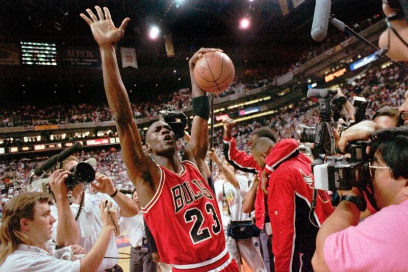 Jordan celebrates after the Bulls beat the Phoenix Suns 99-98 to win their third consecutive NBA title. AP