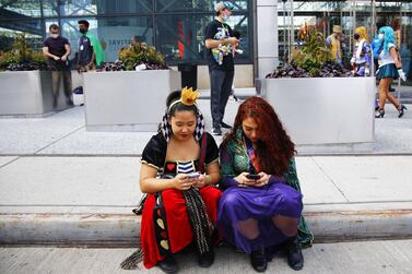 NEW YORK, NEW YORK - OCTOBER 07: Khin Phyu, cosplaying as the Queen of Hearts, and Samantha Reynoso, dressed as a Hocus Pocus witch, wait for a friend in front of the Jacob Javits Center for the NYC Comic-Con on October 07, 2021 in New York City.  NYC Comic-Con convention began today and will be open through Sunday after being postponed last year due to the coronavirus (COVID-19) pandemic.  The event will be adhering to NYC's health and safety protocols requiring attendees to show proof of vaccination or proof of a negative coronavirus (COVID-19) test and wear a mask while indoors.    Michael M.  Santiago / Getty Images / AFP
