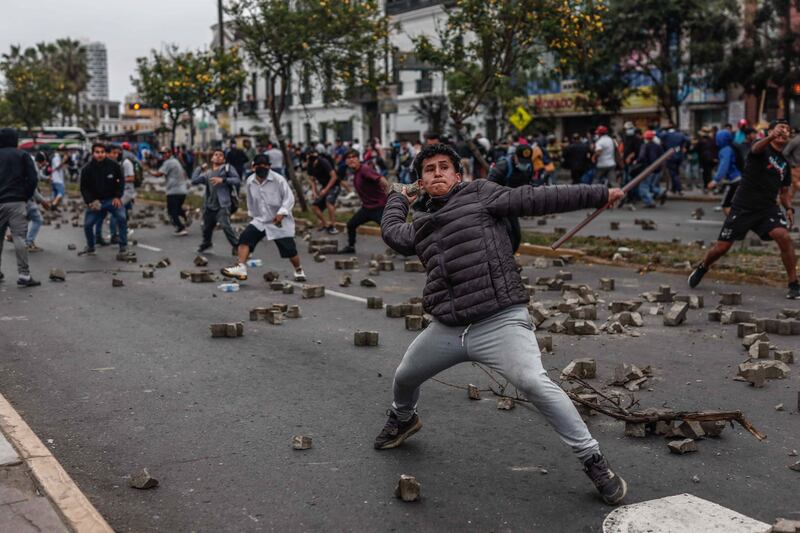 Protesters and police clash in Lima, Peru, on December 7.  EPA