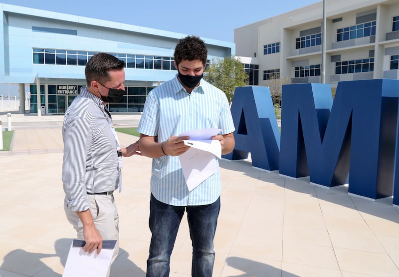 Pupil Kareem Baloawi discusses his GCSE results with Adrian Frost, Principal of Amity International School in Abu Dhabi