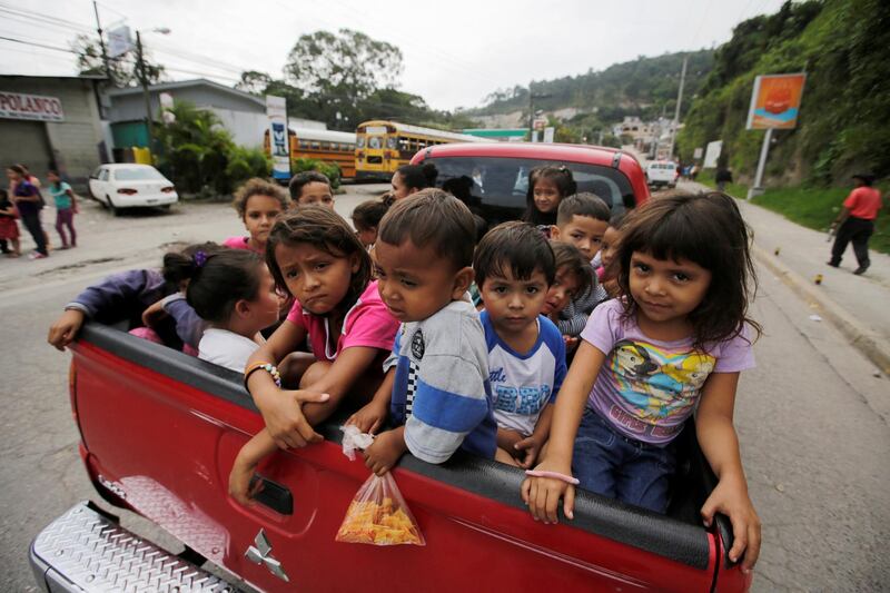 Honduran children in Santa Rosa de Copan fleeing poverty are packed into a pick-up heading towards the US. Reuters