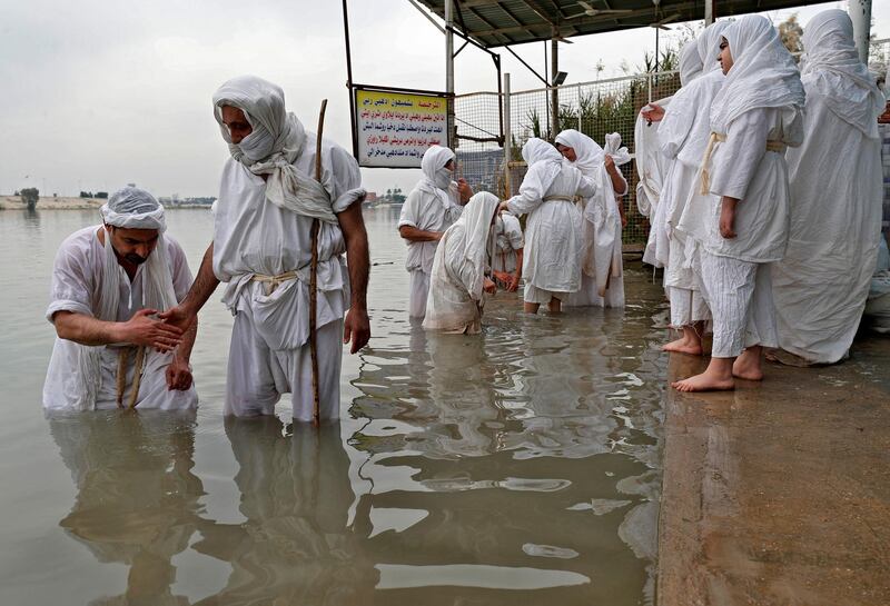 Iraqi Mandaeans perform a ritual on the banks of the Tigris in Baghdad. AFP