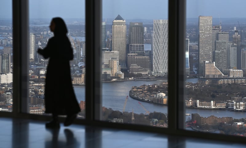 A Muslim woman views Canary Wharf in the City of London during an Iftar event at 22 Bishopsgate. EPA
