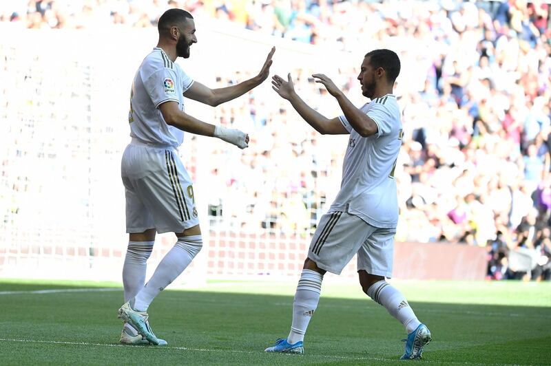 Real Madrid's French forward Karim Benzema, left,  celebrates scoring the opening goal. AFP