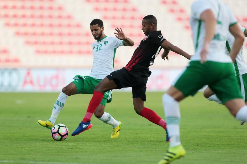 Emirates’ Abdulla Ali, left, and Al Ahli’s Saeed Ahmed, centre, battle for the ball during their Arabian Gulf League match in Dubai on Saturday. Christopher Pike / The National