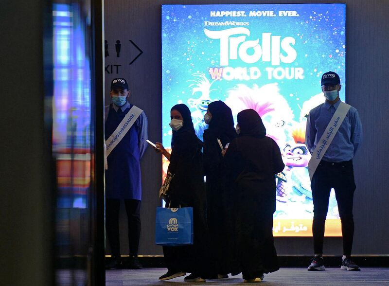 Saudi women enter a movie theatre at a cinema in the Saudi capital Riyadh, on June 22, 2020 as cinemas re-opened following the lifting of a lockdown due to the COVID-19 coronavirus pandemic. (Photo by FAYEZ NURELDINE / AFP)