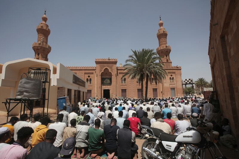 Men pray at the Grand Mosque in Khartoum. AP