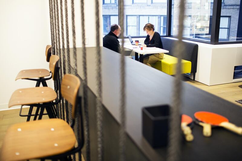 Employees sit in a booth at the Assemblyon2 common space, an amenities floor open to companies in the building, inside the Equity Office Management LLC 100 Summer Street offices in downtown Boston, Massachusetts, U.S., on Wednesday, Jan. 3, 2018. Companies in every industry, from autos to retail, have been scrambling to adjust to millennials' tastes and expectations, and commercial real estate is no exception. Blackstone Group LP, Brookfield Property Partners LP, Boston Properties, and other big landlords are spending millions to inject Silicon Valley playfulness into aging towers in big cities. Photographer: Adam Glanzman/Bloomberg