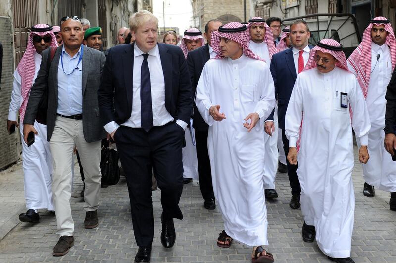 Saudi Foreign Minister Adel al-Jubeir (C-R) and his British counterpart Boris Johnson (C-L) tour the historic quarter of Jeddah on January 25, 2018. (Photo by STRINGER / AFP)