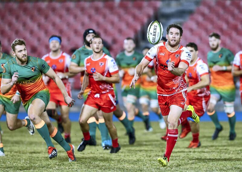 Dubai, United Arab Emirates, November 8, 2019.  
SUBJECT NAME / MATCH / COMPETITION: West Asia Premiership: Dubai Knights Eagles v Dubai Tigers, Domestic top division match.
--(Right)  Peter Kelly of Dubai Tigers passes the ball forward during their match against the Dubai Knights Eagles.
Victor Besa/The National
Section:  SP
Reporter:  Paul Radley