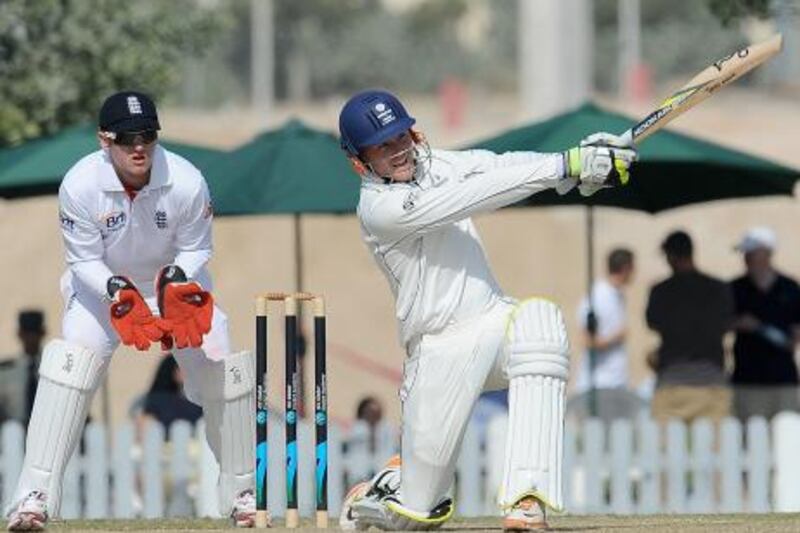 England XI wicket keeper Steven Davies (L) watches ICC Combined Associate and Affiliate XI cricketer Christi Viljoen (R) playing a shot during the opening day of a three-day practice match between the England XI and ICC Combined Associate and Affiliate XI at The ICC Global Cricket Academy in Dubai Sports City on January 7, 2012. England plays three Tests, four one-day internationals and three Twenty20s against Pakistan in the United Arab Emirates between January 17 and February 27.  AFP PHOTO/Lakruwan WANNIARACHCHI
 *** Local Caption ***  593879-01-08.jpg