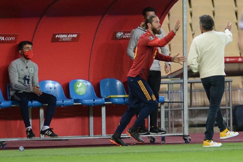 Spain's defender Sergio Ramos shakes hands with coach Luis Enrique. AFP