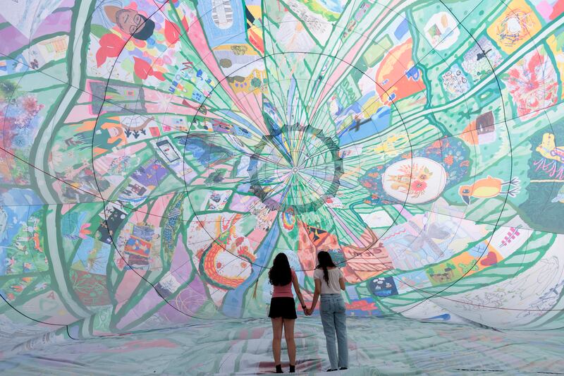 Twins Gonul and Goode Ali attend the flight of new artwork 'Fields of EveryWhen', a spectacular hot air balloon celebrating the people and places of Thamesmead, south-east London, by artists musson+retallick. Getty Images