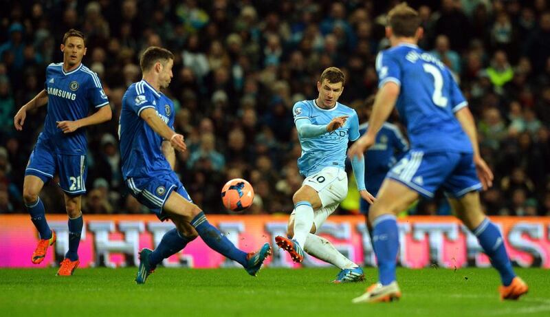 Manchester City's Bosnian striker Edin Dzeko shoots during the match. Paul Ellis / AFP