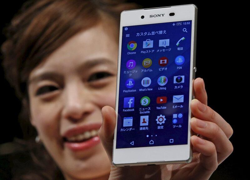 A model poses with Sony's new Xperia Z4 smartphone after a news conference in Tokyo on April 20, 2015. Sony Corp on Monday unveiled the new high-end Xperia handset featuring an aluminium frame and a 5.2-inch screen, showing it is still in the smartphone race even as it scales down its struggling mobile operations.   Toru Hanai / Reuters