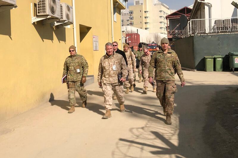 FILE - In this Jan. 31, 2020, file photo Marine Gen. Frank McKenzie, center, top U.S. commander for the Middle East, makes an unannounced visit in Kabul, Afghanistan. Six months after a deadly American airstrike in Baghdad enraged Iraqis and fueled demands to send all U.S. troops home, McKenzie is talking optimistically about keeping a smaller, but enduring military presence in Iraq. (AP Photos/Lolita Baldor, File)