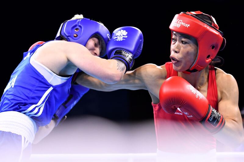 Northern Ireland's Kristina O'Hara (L) fights with India's Mary Kom during their women's 45-48kg final boxing match during the 2018 Gold Coast Commonwealth Games at the Oxenford Studios venue on the Gold Coast on April 14, 2018. / AFP PHOTO / Anthony WALLACE