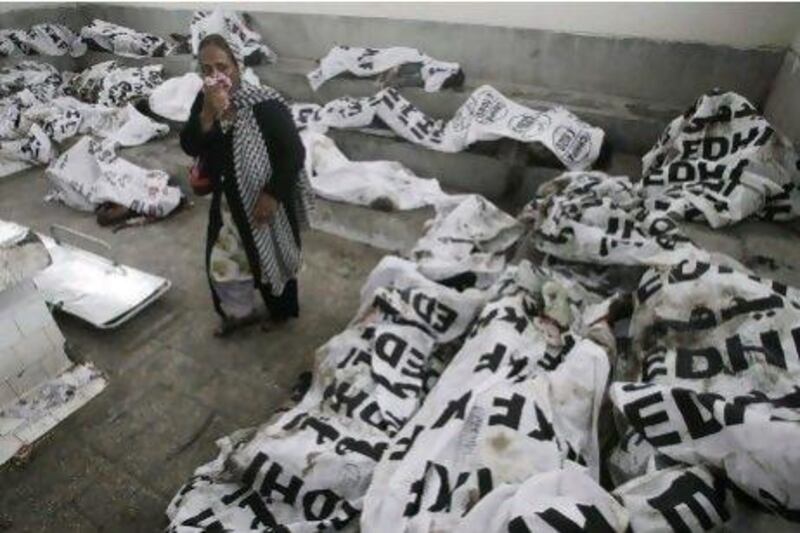 A woman looks for her missing family member at a Karachi morgue after the factory fire.