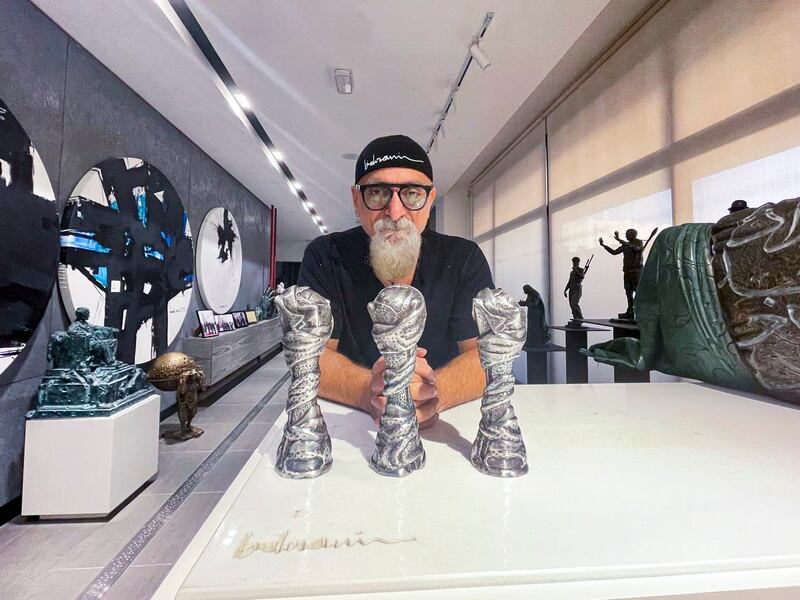 Iraqi sculptor Ahmed Al Bahrani with replicas of the Gulf Cup trophy he created. Photo: Ahmed Al Bahrani