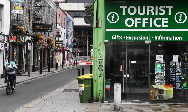 A Deliveroo delivery cyclist passes by a closed tourist information office in Dublin, Ireland, on Monday, Aug. 10, 2020. Ireland is one of the most open countries in the world in economic terms, according to the KOF Globalisation Index, having built its economic strategy on a low corporate tax rate and a plentiful supply of well-educated, English-speaking workers. Photographer: Aidan Crawley/Bloomberg