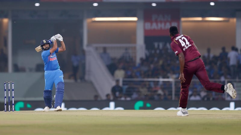 India's Rohit Sharma hits a six off Oshane Thomas during the second Twenty20 international cricket match between India and West Indies at Bharat Ratna Shri Atal Bihari Vajpayee Ekana Cricket Stadium in Lucknow, India, Tuesday, Nov. 6, 2018. (AP Photo/Altaf Qadri)