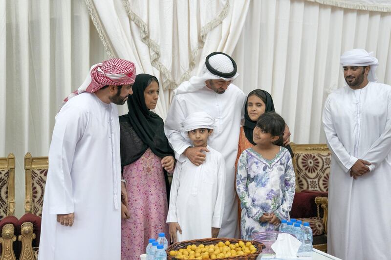 SHAWAMEKH, ABU DHABI, UNITED ARAB EMIRATES - September 15, 2019: HH Sheikh Mohamed bin Zayed Al Nahyan, Crown Prince of Abu Dhabi and Deputy Supreme Commander of the UAE Armed Forces (3rd L), offers condolences to the family of martyr Warrant Officer Zayed Musllam Suhail Al Amri.

( Mohamed Al Hammadi / Ministry of Presidential Affairs )
---