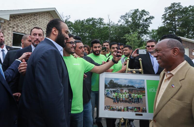 Houston Mayor Sylvester Turner watches a volunteer take a selfie with Saudi Crown Prince Mohammed bin Salman in front of a Habitat for Humanity home in Houston. Steve Gonzales / AP Photo