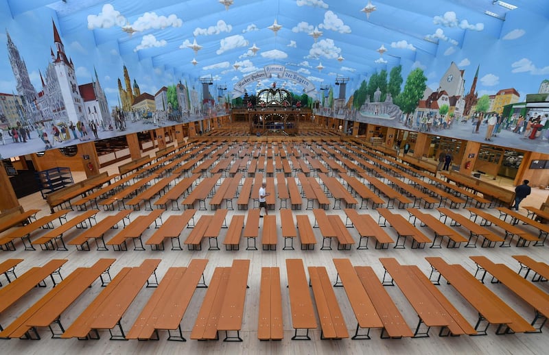 (FILES) This file photo taken on September 16, 2016 shows empty beer benches in a festival tent as preparations were under way for the opening of the Oktoberfest beer festival at the Theresienwiese fair grounds in Munich, southern Germany. Germany's Oktoberfest beer festival will be cancelled in the year 2020 as "risks are too high" from the novel coronavirus, Bavarian state premier Markus Soeder said Tuesday, April 21, 2020. / AFP / CHRISTOF STACHE
