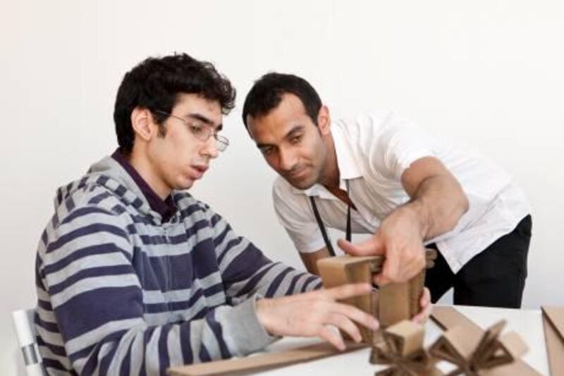 Abu Dhabi, UAE (07/11/2010)  Participant Istanbraq Emad [L] and Designer Khalid Shafar [R] build wall art out of cardboard at the Campana Design Workshop . The workshop is part of the Abu Dhabi Art Design Tent at the Emirates Palace, Abu Dhabi. (Callaghan Walsh / for The National)