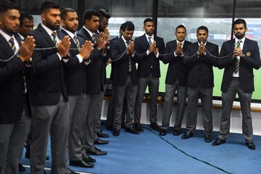 Sri Lanka's cricket captain Lahiru Thirimanne (right) and teammates look on as Buddhist monks chant prayers for their success during a ceremony in Colombo on Septemer 24, 2019, prior to the team's departure for their tour in Pakistan. AFP