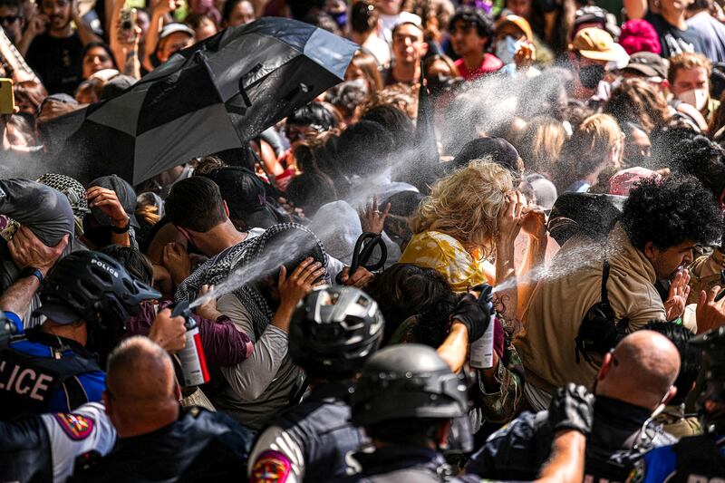 A state trooper pepper-sprays pro-Palestinian protesters after police vehicles were blocked at the University of Texas in Austin. Reuters