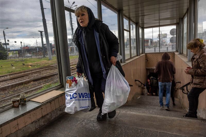 A woman displaced by incessant Russian shelling leaves a metro station where people had been living underground for months in Kharkiv, Ukraine. Getty