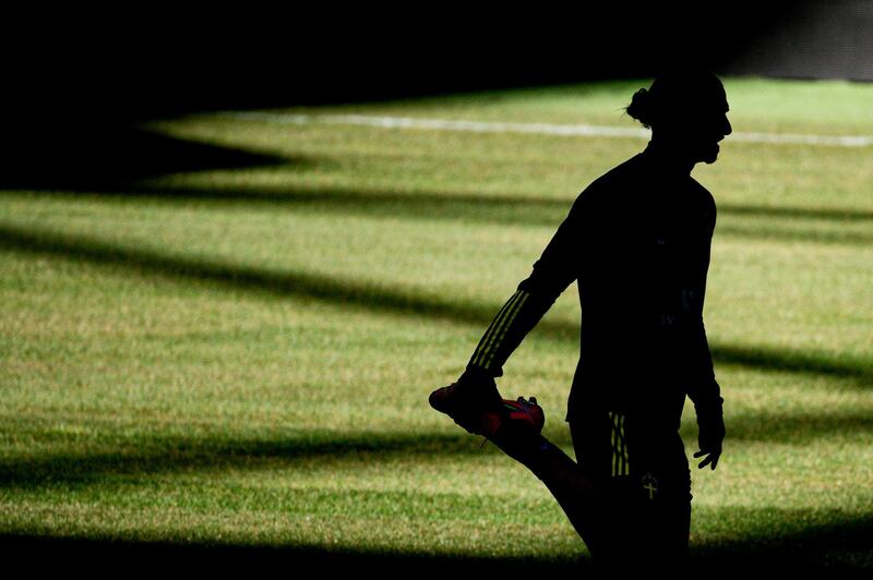 The silhouette of Sweden forward Zlatan Ibrahimovic is seen as he warms up for a training session. AFP