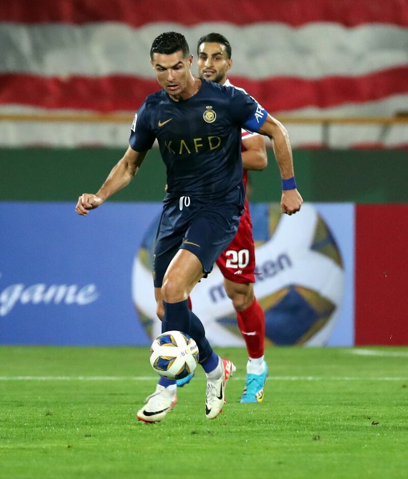 Cristiano Ronaldo of Al Nassr vies with Shahab Zahedi of Persepolis. EPA