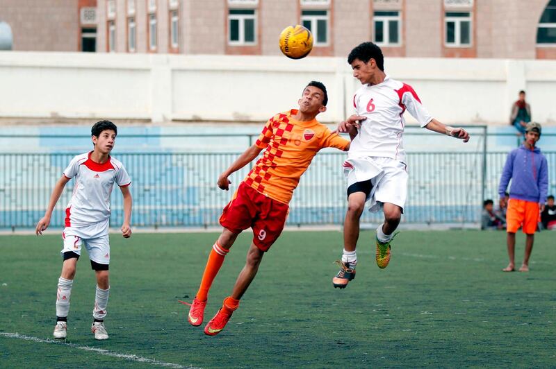 Yemeni youth take part in a football match as part of the local league in the capital Sanaa. Mohammed Huwais / AFP