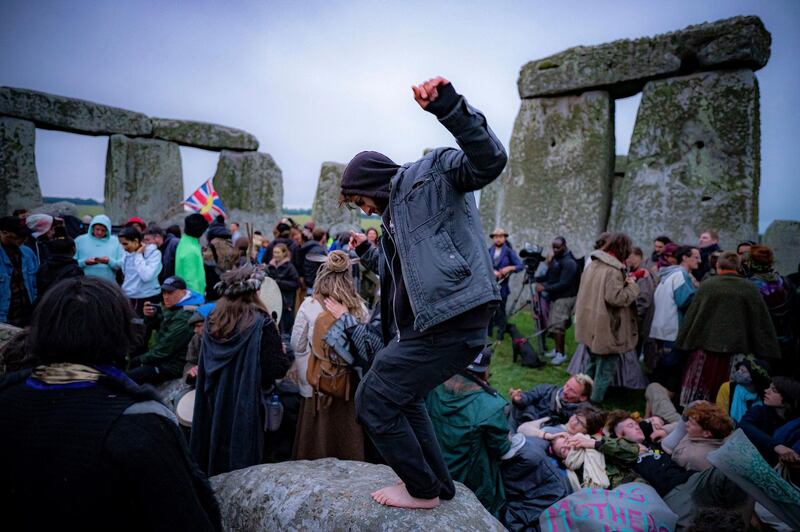 People inside the stone circle during Summer Solstice at Stonehenge. The prehistoric monument of ancient stones have been officially closed for the celebrations due to the coronavirus lockdown, but groups of people ignored the lockdown. AP Photo