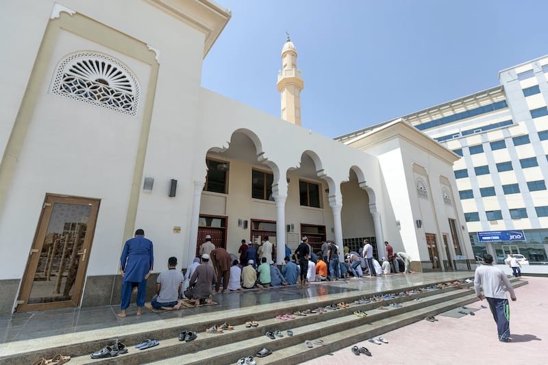 Dubai, United Arab Emirates - Reporter: N/A: People come together to pray outside a mosque in Dubai Investment Park after suspension of public prayers in all places of worship in the UAE. Friday, March 20th, 2020. DIP, Dubai. Chris Whiteoak / The National