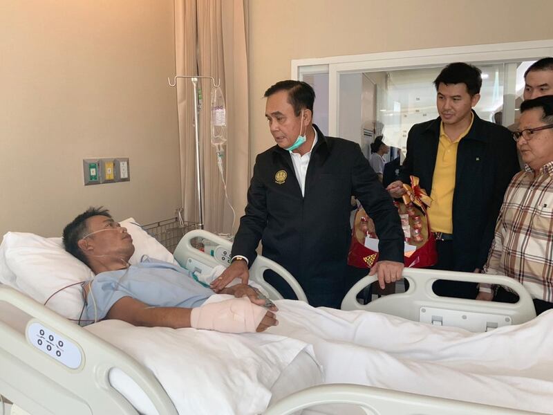 Thai Prime Minister Prayut Chan-o-cha (C) visiting a person injured during a mass shooting at the Terminal 21 shopping mall; at a hospital in Nakhon Ratchasima, Thailand.  EPA
