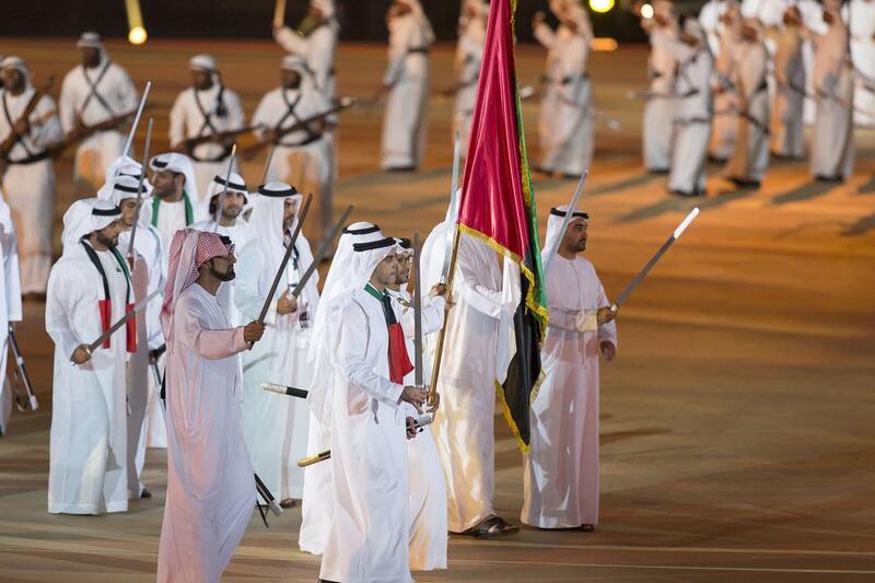 Lt Genl Sheikh Saif bin Zayed, Deputy Prime Minister and Minister of Interior (C) and Sheikh Ammar bin Humaid, Crown Prince of Ajman (centre L) dance during the 44th UAE National Day celebrations at Zayed Sports City. Mohamed Al Hammadi / Crown Prince Court - Abu Dhabi