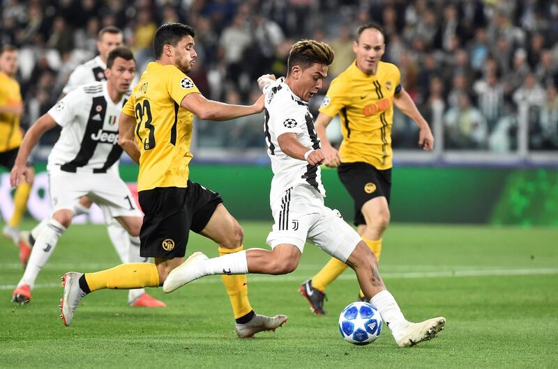 Soccer Football - Champions League - Group Stage - Group H - Juventus v BSC Young Boys - Allianz Stadium, Turin, Italy - October 2, 2018  Juventus' Paulo Dybala in action with Young Boys' Loris Benito   REUTERS/Massimo Pinca