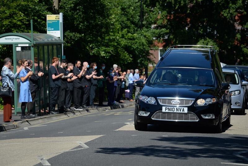The funeral cortege passes the entrance of the Southampton General Hospital in England. Hospital porter Mike Brown died aged 61 at the hospital, where he had worked for 20 years, after testing positive for Covid-19. Getty Images