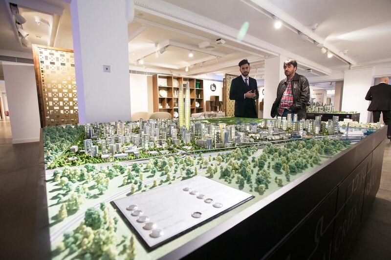 Visitors take a look at the Dubai Creek Harbour model. Courtesy Emaar / Harrods Estates