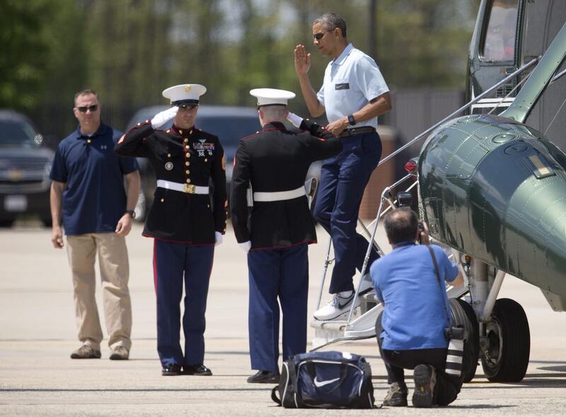 President Barack Obama salutes as he steps off of Marine One, in Andrews Air Force Base, as he returns from the presidential retreat at Camp David. Carolyn Kaster / AP Photo