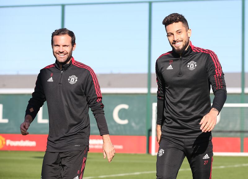 Juan Mata and Alex Telles of Manchester United in action during a first team training session at Carrington Training Ground.