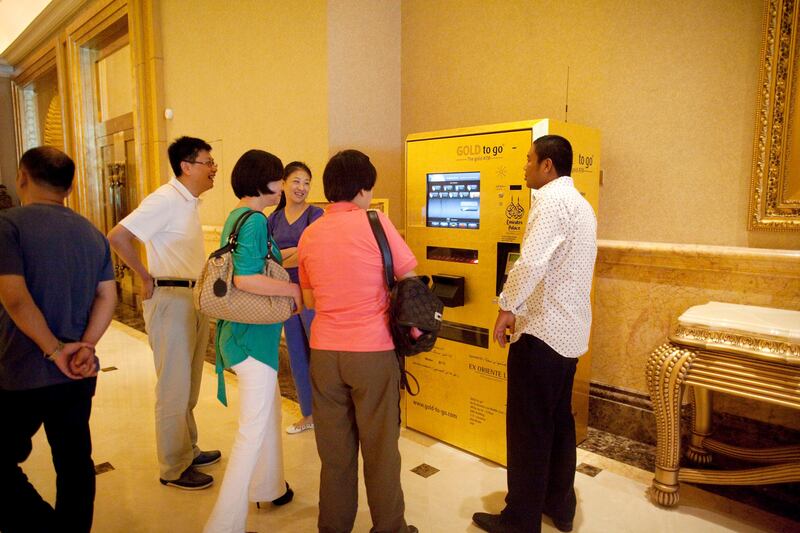 Abu Dhabi, United Arab Emirates, July 15, 2013:     Tourists look at a gold vending machine at Emirates Palace in Abu Dhabi on July 15, 2013. Christopher Pike / The National

Reporter: GILLIAN DUNCAN *** Local Caption ***  CP0715-emirates palace026.JPG